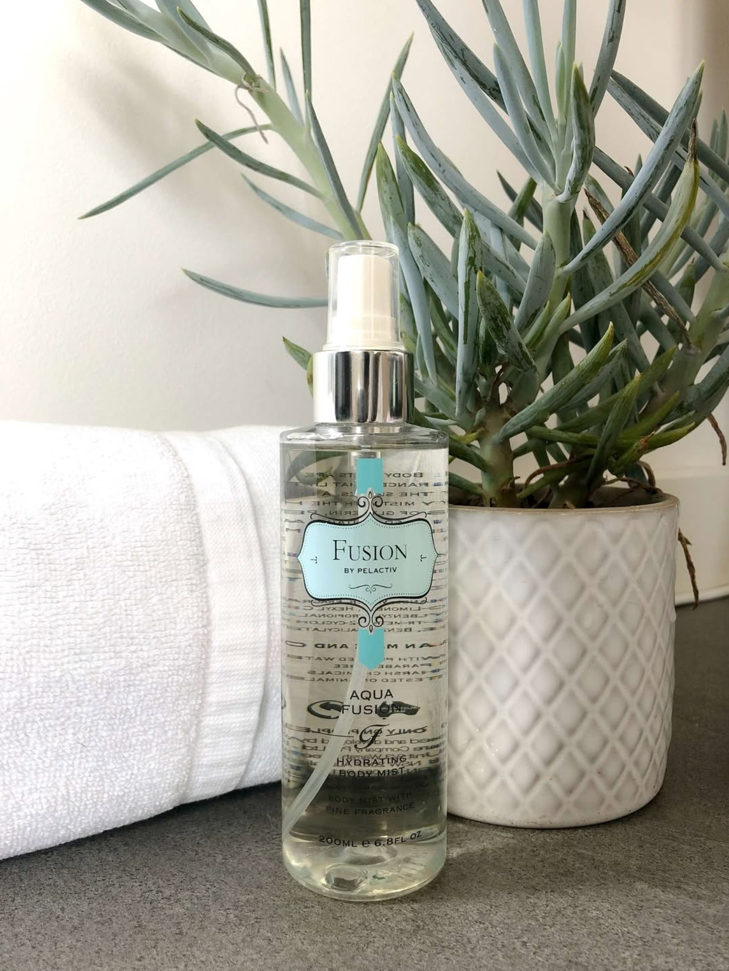 Fusion Aqua Hand Wash next to Aloe Vera Plant and Towel
